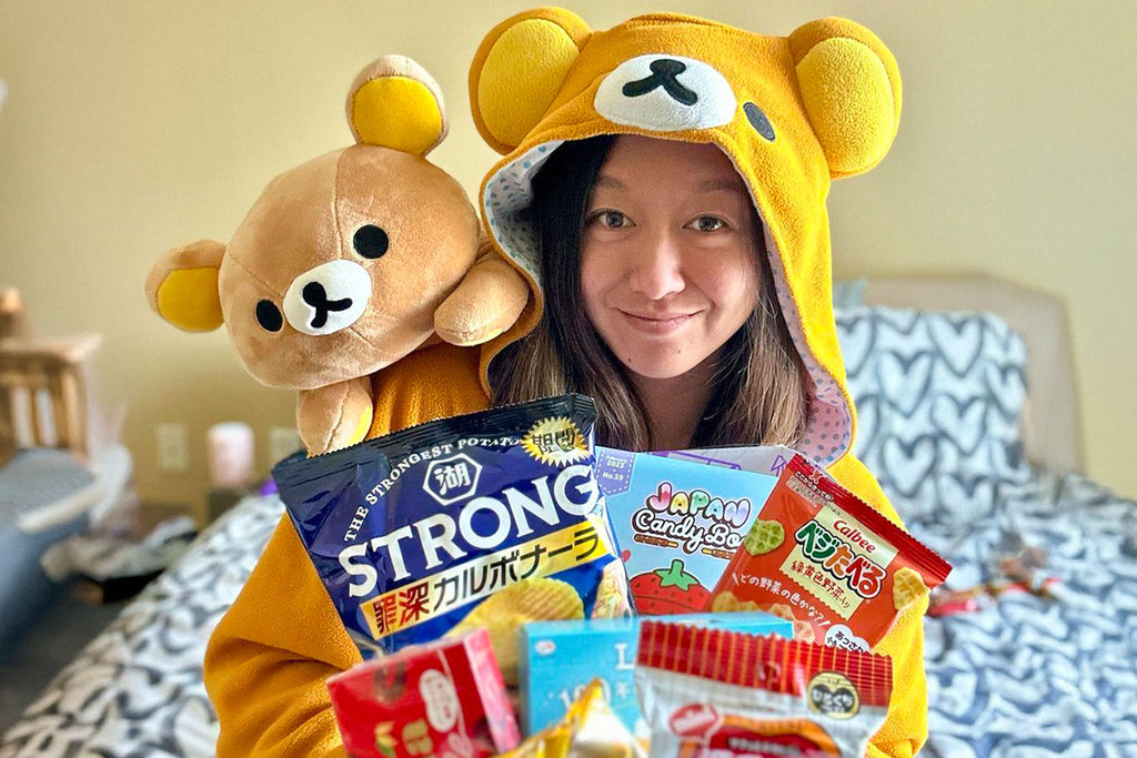 Person holding Japanese candy and snacks